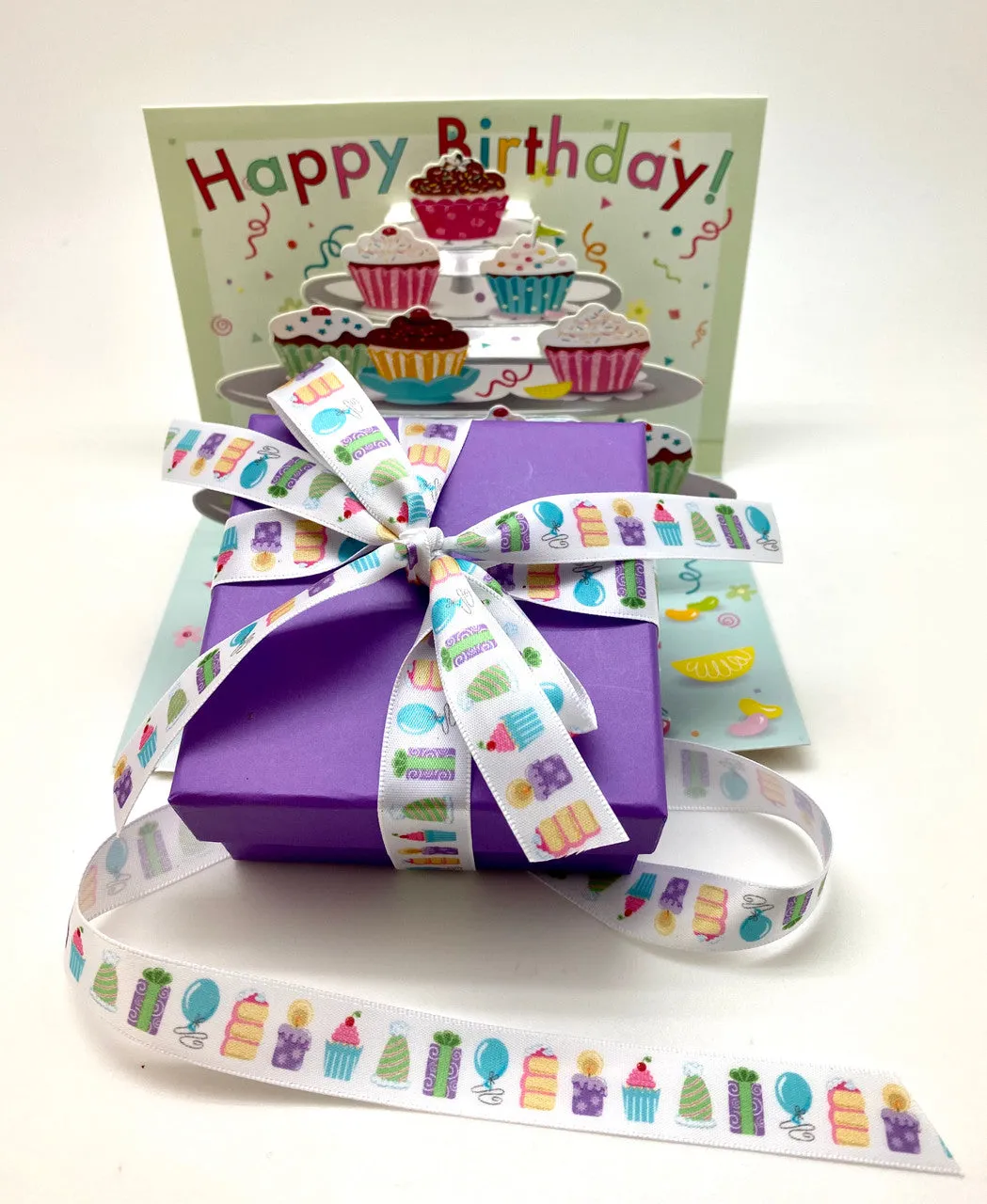 Birthday Party ribbon with cake, gifts, party hats and cupcakes printed on 5/8" white satin ribbon